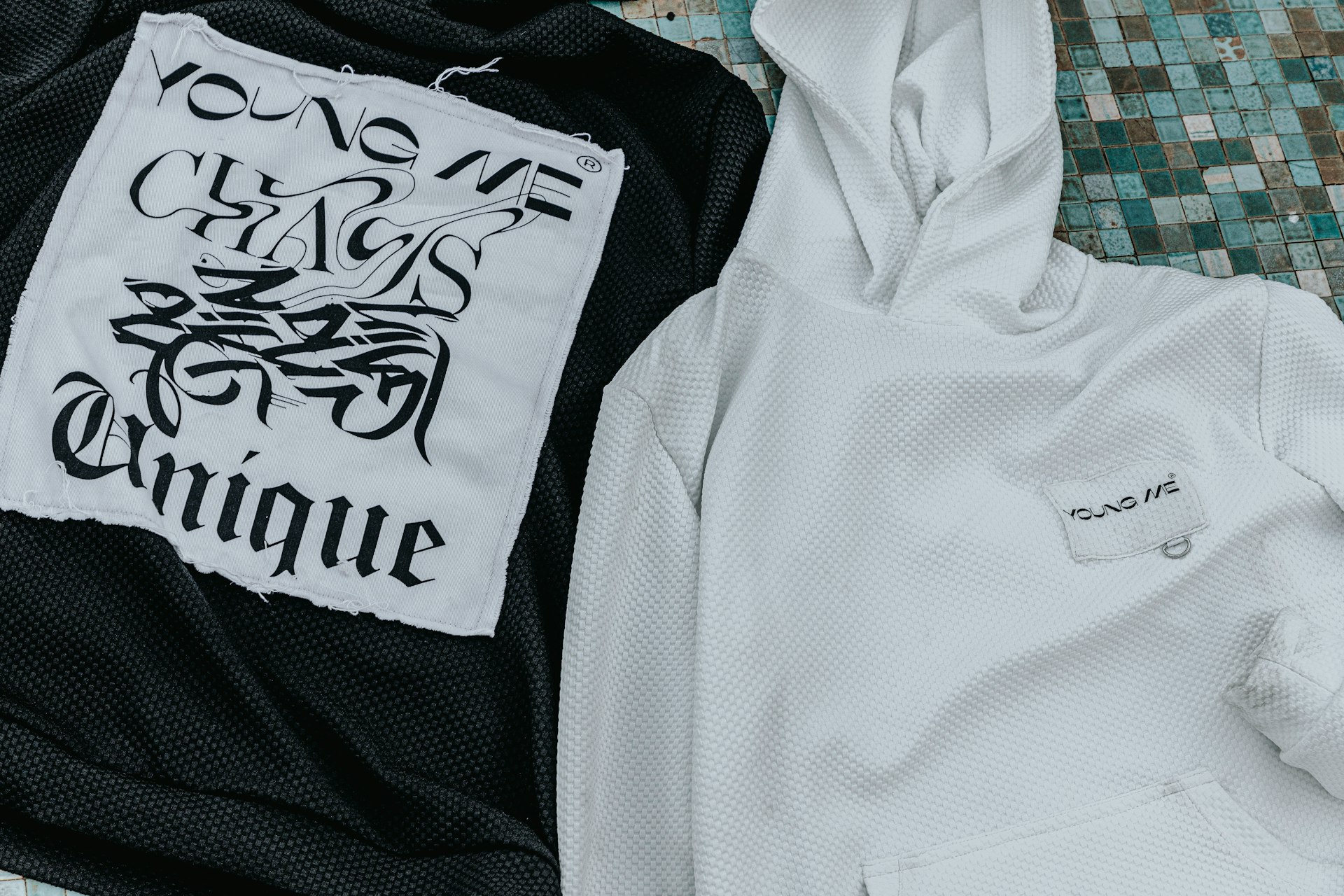 A black and white hoodie and a white shirt